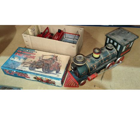 A vintage boxed battery tinplate operated fire engine and a similar train 