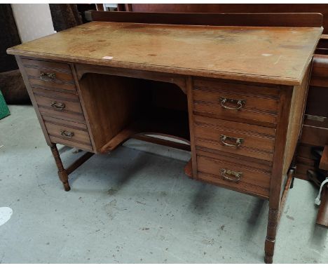 An Edwardian mahogany desk with three drawers to either side and shelf under with cut out for sitting, Length 116cm 