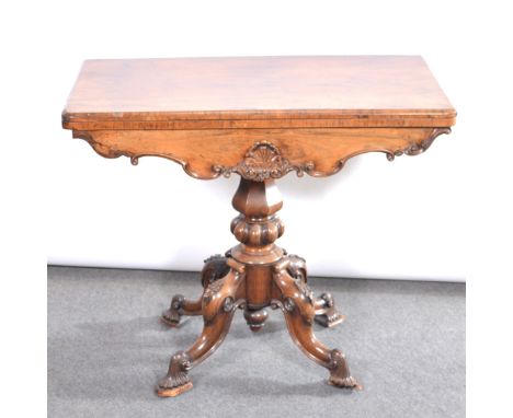 Victorian rosewood card table, rectangular foldover top enclosing a baize lined interior, shaped frieze, octagonal and fluted