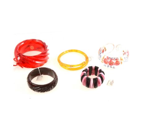 A marbled lucite and paste 'snake' bangle, 13mm width, 73mm internal diameter; an Art Deco style pink and black glass paneled