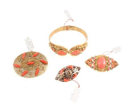 Faux coral jewellery in the style of Max Neiger of Gablonz, a gilt metal hinged bangle with raised detail holding faux coral 