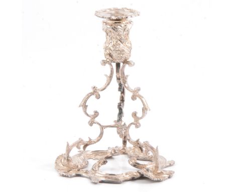 A silver candlestick, Walker &amp; Hall, Sheffield 1979, wrythen-fluted sconce deocrated with grapes and vines, flying scroll