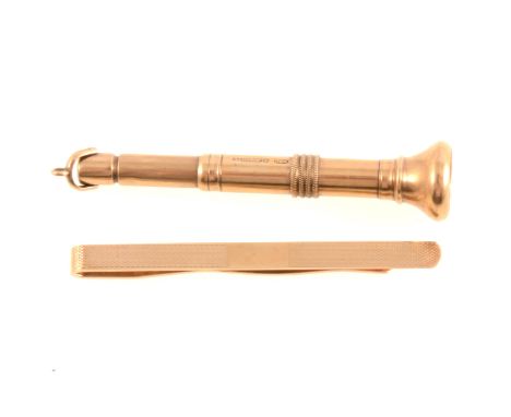 A 9 carat yellow gold cigar piercer Birmingham 1935, 7cm, 11.8gm including the metal piercer, a 9 carat yellow gold tie bar, 