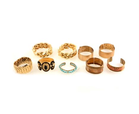 A pair of Kigu gilt metal hinged bracelets, engine-turned, 28mm width, 58mm internal diameter; a pair of Ungaro gilt metal hi