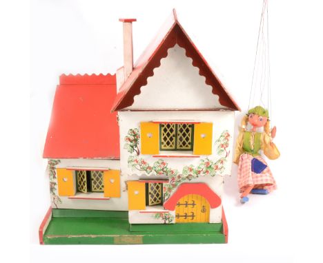 Swedish chalet doll's house and a Pelham Puppet, Tyrolean Girl, in box.