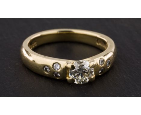 An 18ct yellow gold and diamond ring, with claw set 0.34ct G-H VVS brilliant cut diamond and six small brilliant cut diamonds
