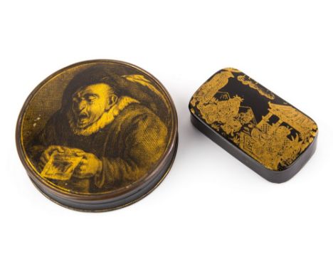 A 19th century papier-mache snuff box, counter form bearing gilt figural lid on black lacquer ground, lacquered base, 3½in. d