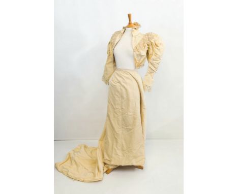 A Victorian wedding dress, the short cotton jacket with high vertical pleated collar, lace surround to shoulders and breast, 