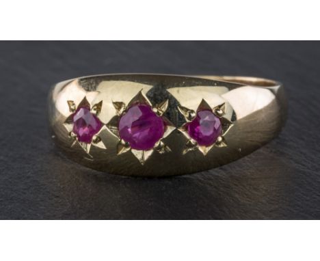 A 9ct gold and three stone ruby gypsy ring, ring size O.