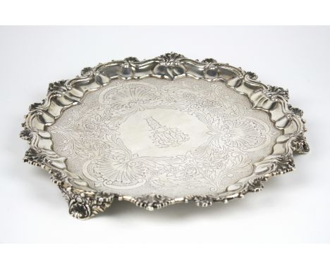 A George IV shaped circular silver salver, William Bateman, London 1829, with shell and scroll Chippendale rim, the plate lat