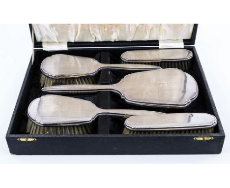 A cased George V silver brush and mirror set, Adie Bros. Ltd., Birmingham 1922, comprising a hand mirror, two handled brushes