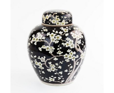 A Chinese black ground ginger jar and cover, 19th century, ovoid form with white enamelled blossoming Prunus branches over bl