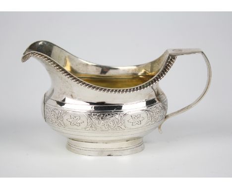 A George III silver helmet cream jug, maker possibly George Wintle, London 1814, with gadrooned rim, chamfered scroll handle 
