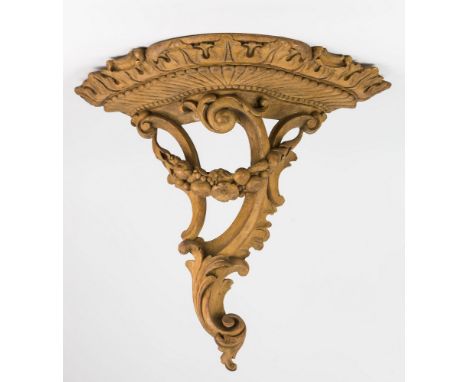 A carved lime wood bracket, 18th / early 19th century, shaped demi-lune plate the underside with carved acanthus design over 