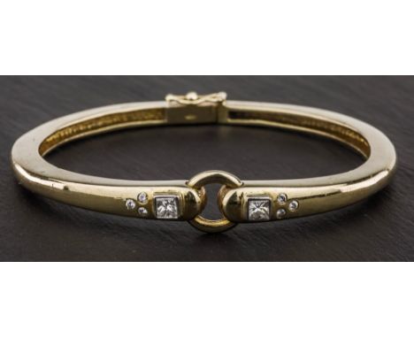An 18ct yellow gold and diamond bangle by Catherine Best, the circular bangle with gold hoop hinge, set to either side with a
