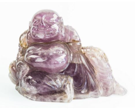 A Chinese carved amethyst figure of Buddha, probably late 19th / early 20th century, the Buddha depicted in semi recumbent po