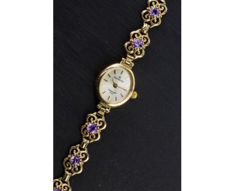 A 9ct gold and amethyst ladies cocktail watch by Sovereign, the oval champagne dial with gilt baton markers, signed 'Sovereig