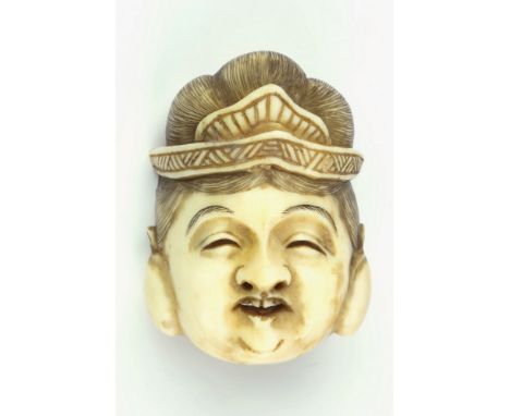 A Japanese carved ivory female mask form netsuke, 19th century, double character mark to reverse, 1¾in. (4.5cm.) long, * Prov