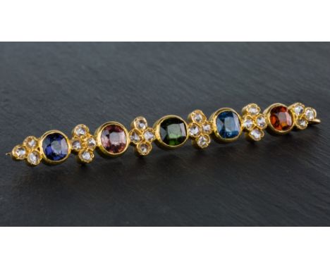 An antique 18ct yellow gold, diamond and multi gemstone bar pendant brooch, set with five gemstones of various cuts, includin