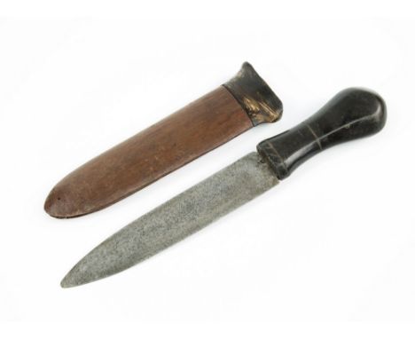 An early 20th century African tribal dagger, waisted form horn handle into broad steel blade, dark hardwood scabbard with hor