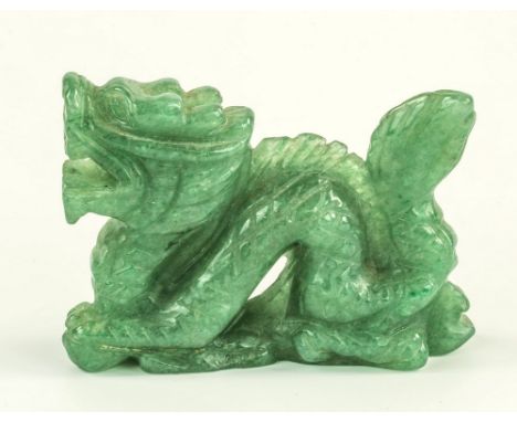 A Chinese carved green jade miniature dragon, 20th century, 2¼in. (5.7cm.) long.
* Condition: Minute chip to edge of base. Ot