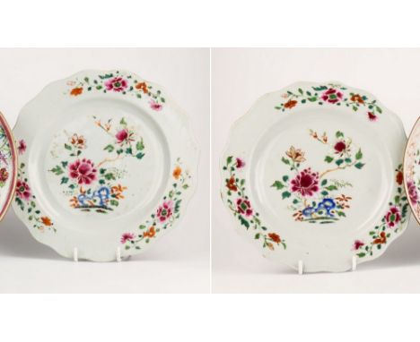 A pair of Chinese 18th century famille rose plates, the undulating rims with three floral trails, around decoration of peony 