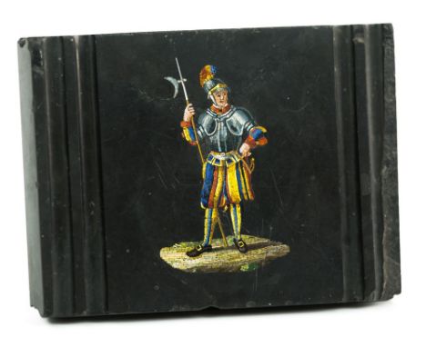 A 19th century Italian micro mosaic paperweight, the rectangular black slate with grooved ends and sides, inset with a finely