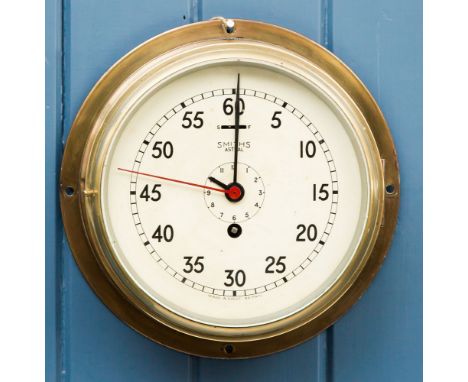 A brass cased Smith's Astral ships bulkhead clock, with brass and bevelled glass porthole style opening door, 8in. white enam
