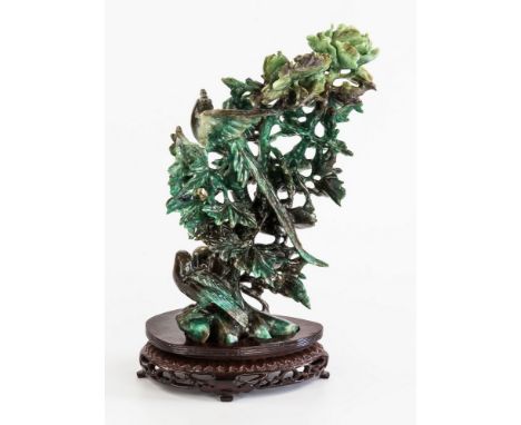 A Chinese mottled green and brown jade figure, late 20th century, depicting a Ho-Ho bird within a flowering peony with four o
