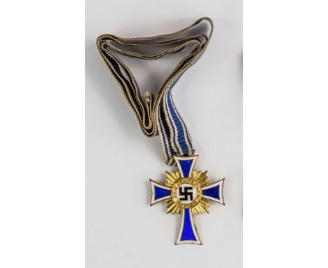 A German 'Der Deutschen Mutter' (German Mothers Cross) medal, cobalt blue enamel cross with white edges on sunburst roundel, 