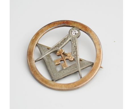 A Victorian rose gold and diamond Masonic Treasurer's brooch, silver square and compass bearing diamond surmount to pivot poi