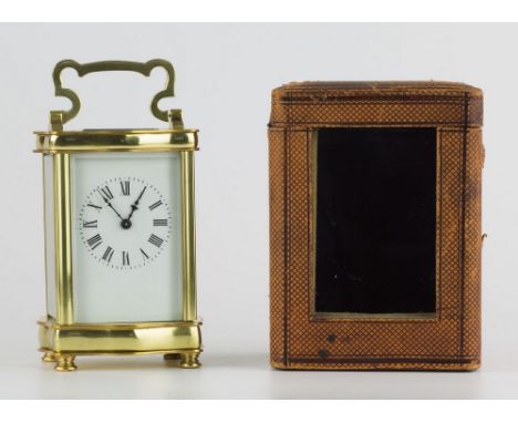 A French gilt brass carriage clock with carrying case, early 20th century, the white enamel Roman dial with blued steel hands