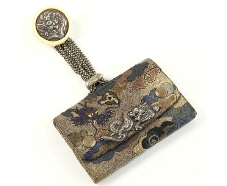 A Japanese Sagemono, Meiji period, leather with silk overlay depicting a dragon amidst clouds, centralised silver dragon appl