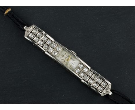 An Art Deco platinum and diamond ladies cocktail watch, with manual wind Juvenia 17 jewel movement, the silvered rectangular 