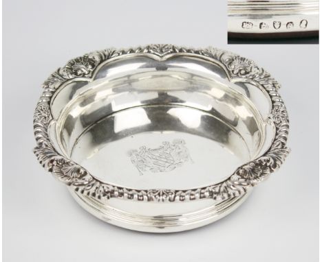 A George IV silver wine coaster by Paul Storr, London 1820, the silver interior with engraved armorial, rising to a scalloped