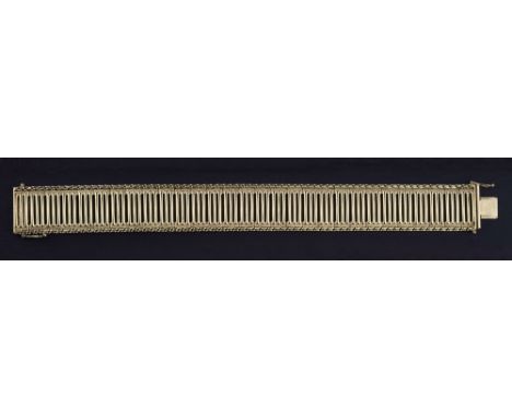 A 9ct gold bar link flexible bracelet, the ladder style bracelet with matted and S-link borders, 7 3/8in. (18.75cm.) long.