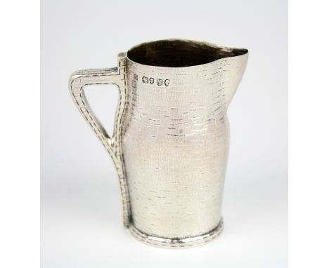 An extremely rare Victorian novelty silver cream jug, Edward Hutton, London 1887, modelled as a leather jack, faux stitched b