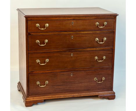 A late George III banded mahogany chest of drawers, the moulded banded top over four long graduated drawers, raised on short 