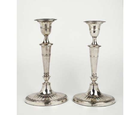 A matched pair of late Victorian silver candlesticks, both Sheffield, Hawksworth Eyre &amp; Co. Ltd. 1894 and Harrison Brothe