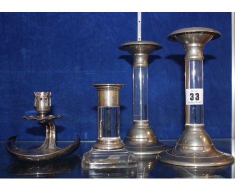 A German silver 800 lily leaf shaped chamber candle stick, a pair of Austrian silver and glass stemmed candle sticks and a sm