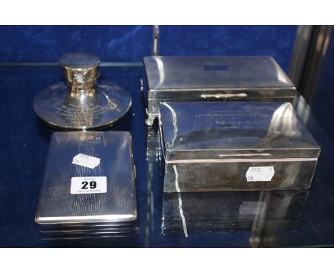 A silver ships inkwell, incorporating a pocket watch to the lid, a silver engine turned cigarette case, a silver cigarette bo