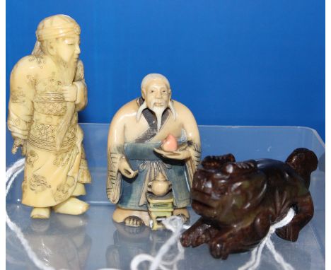 An ivory netsuke of Kwanyu, a hardstone Dog of Fo and a coloured ivory netsuke (3)