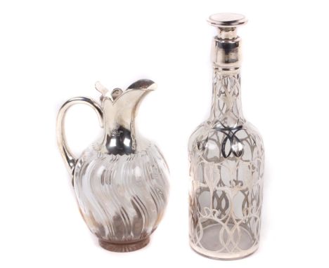 A Victorian silver mounted claret jug, John Grinsell & Sons, London, 1894, of wrythened clear glass baluster form, with a hin