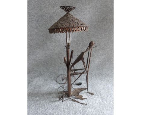 A vintage ironwork seated figure lamp in the style of Giacometti. Pierced conical shade. H 67.5cm 
