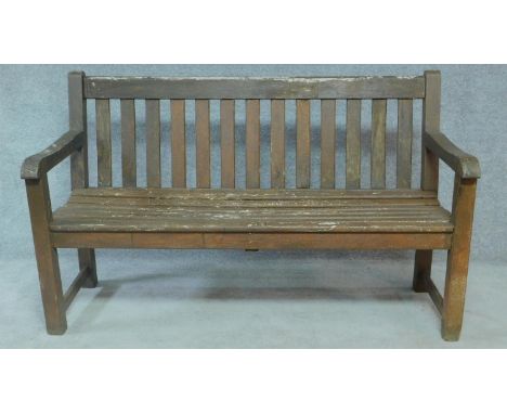 A weathered teak garden bench. H.90 W.148 D.60cm 