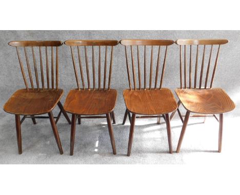 set of four vintage stained beech stick back dining chairs, label to underside. 