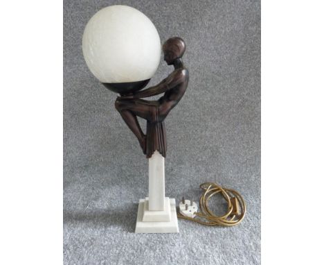 Art Deco style globe lamp with figure of dancer seated on a marble column. Figure made of resin, globe shade made of opaque c