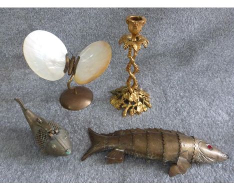 A collection of vintage brass items, including a brass butterfly with oyster shell wings, an articulated brass fish, brass pi