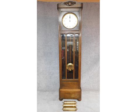 A mid 20th century German oak longcase clock with weights and pendulum. H.202cm (reported as serviced and in working order) 