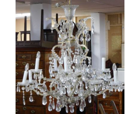 A large sixteen branch chandelier with crystal drops on gilt metal frame. H.105 W.105cm (some drops detached, others missing)